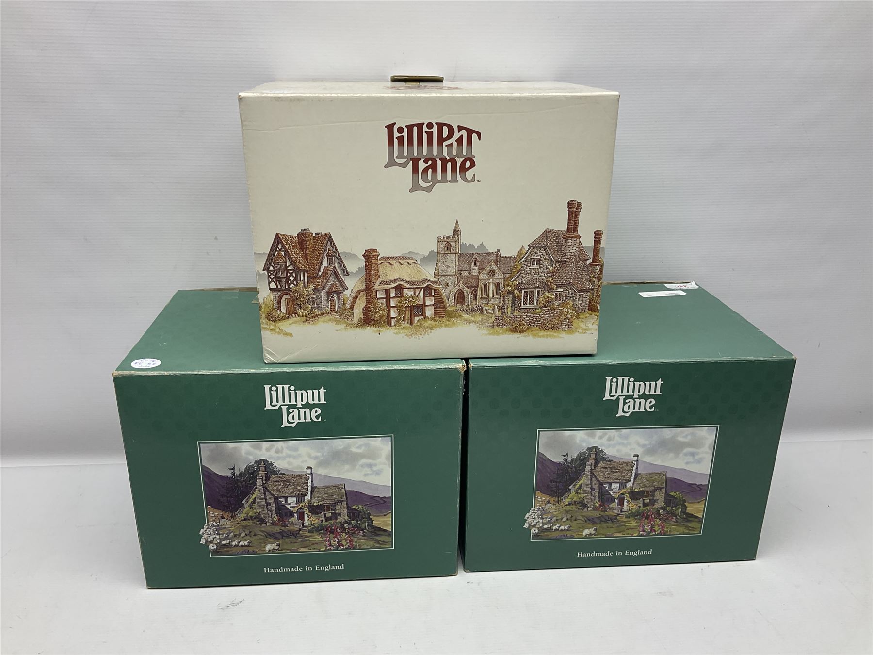 Three Lilliput lanes, comprising Oakwood Smithy, Anne of Cleves and Bluebell Farm, all with deeds and original boxes 