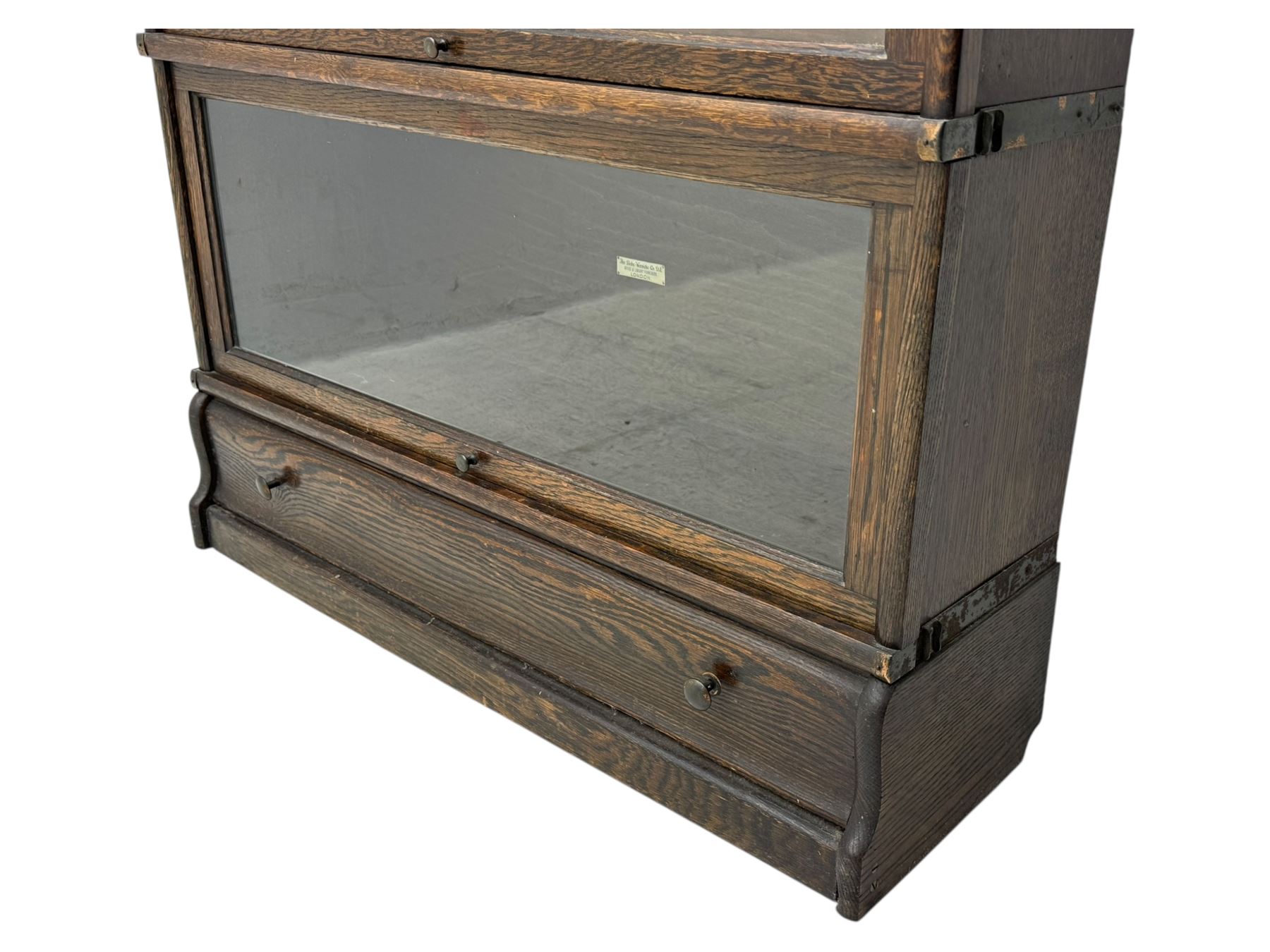 Globe Wernicke - stacking sectional library bookcase, over four glazed up-and-over doors, each bearing original makers mark, on moulded plinth base with inbuilt drawer