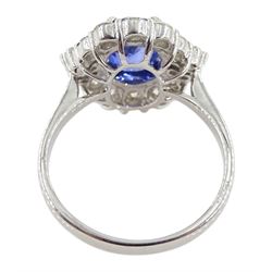 18ct white gold sapphire and diamond cluster ring, the central oval sapphire of approx 2.10 carat, with tapered baguette diamonds and round brilliant cut diamond surround, stamped 750