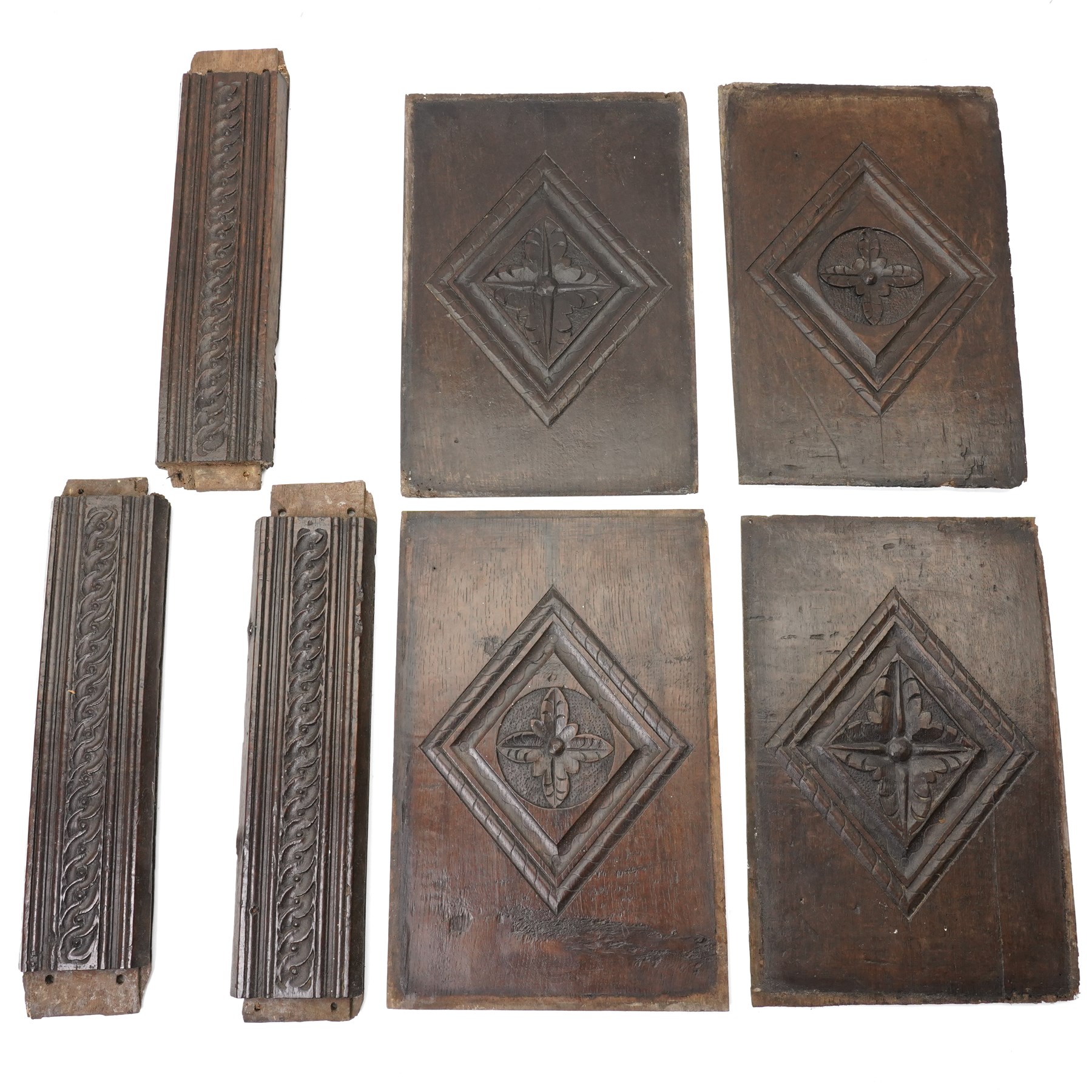 Set of four 17th century carved panels with lozenge decoration, and three further carved panels, lozenge panels approx 36.5cm x 24cm, three further 35cm x 10cm 