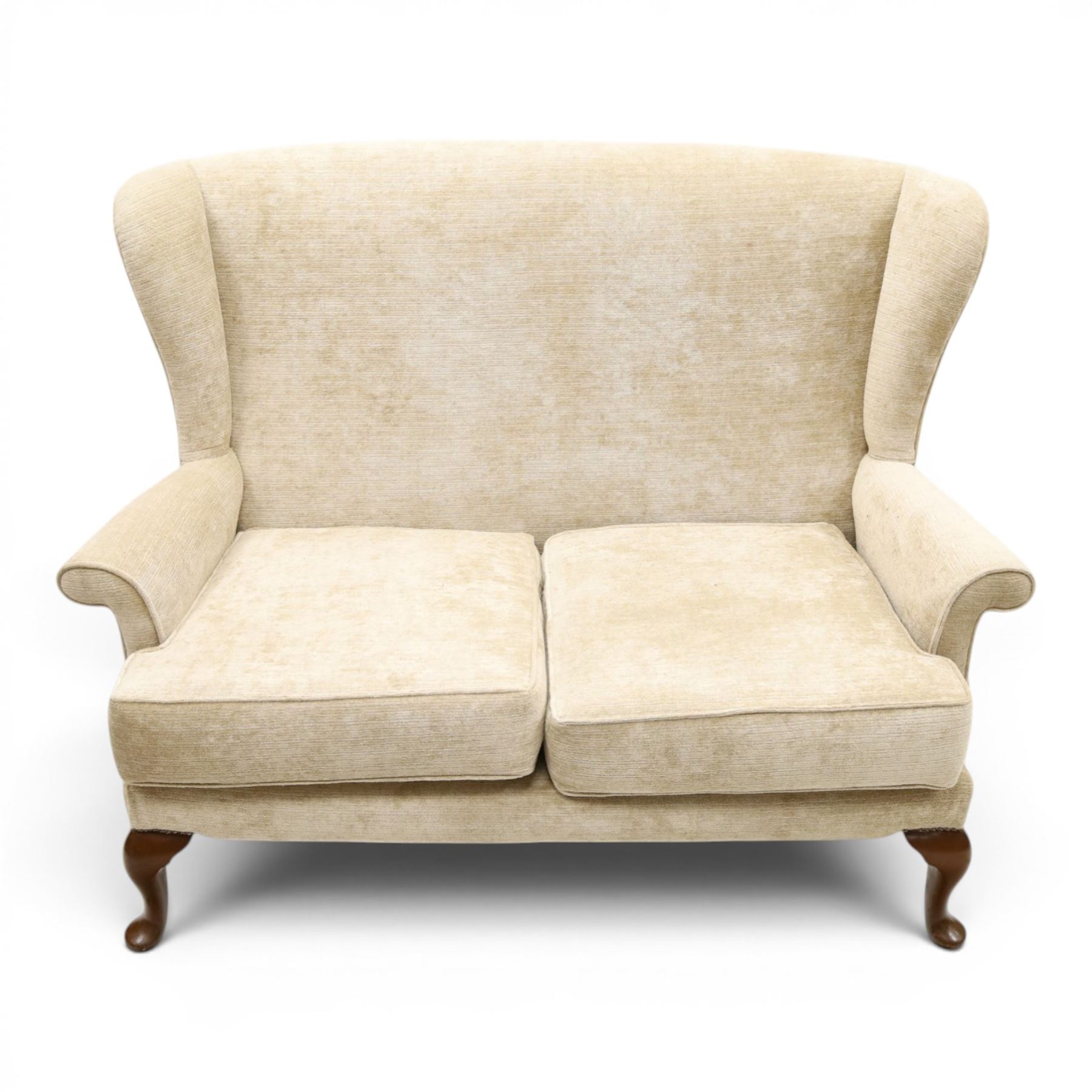 Parker Knoll - 'Hartley' lounge suite, comprising three wingback armchairs and two-seat settee, upholstered in cream fabric, shaped wing backs with scroll-over arms and loose seat cushions, on cabriole supports with pad feet wingbacks and settee

Armchairs: H 96cm, D 83cm, W 75cm