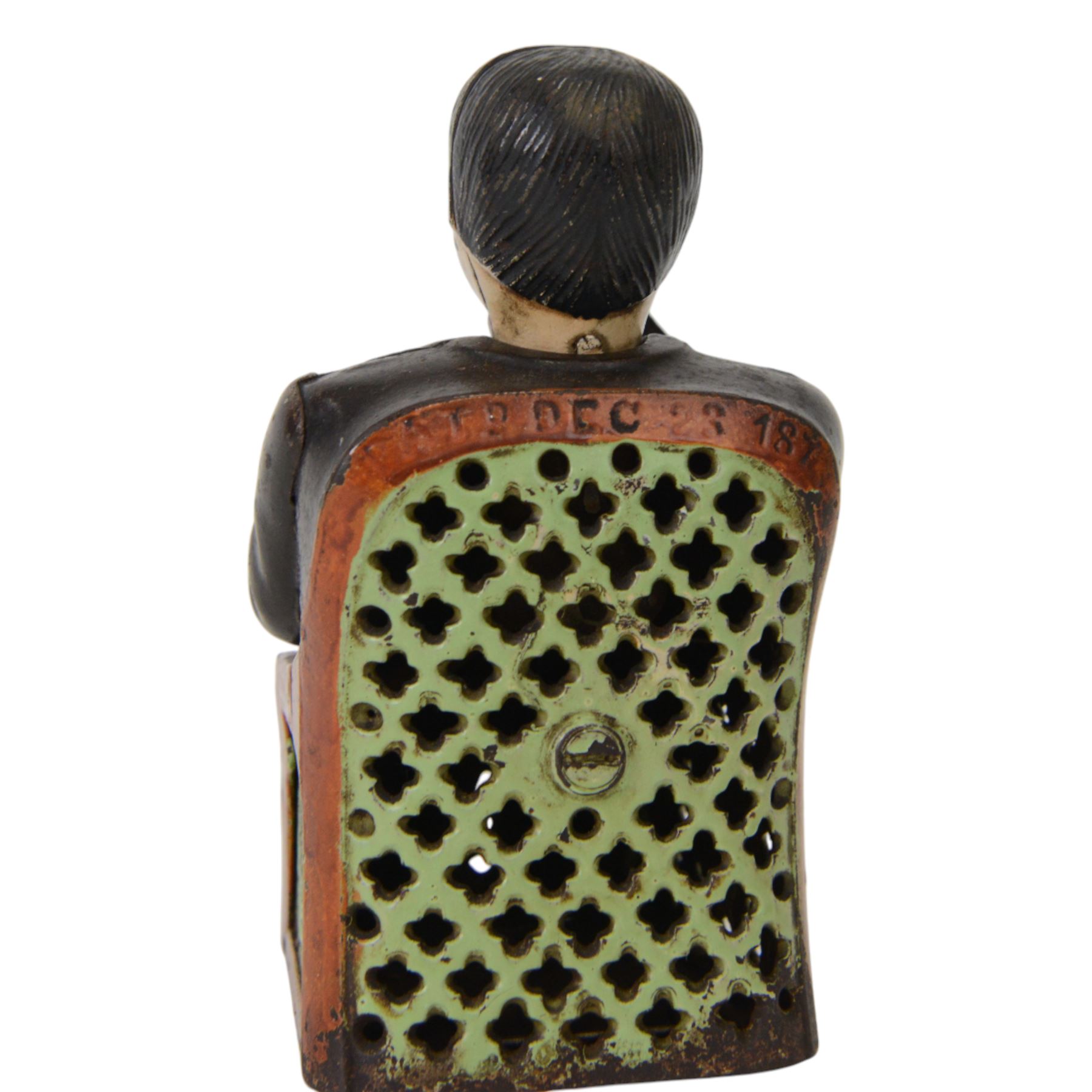 Late 19th century American cast iron Tammany mechanical money box, modelled as a suited gentleman with yellow waistcoat seated in a red and green chair, with two patent marks for Dec 23rd 1873 and June 8th 1875, H14cm
