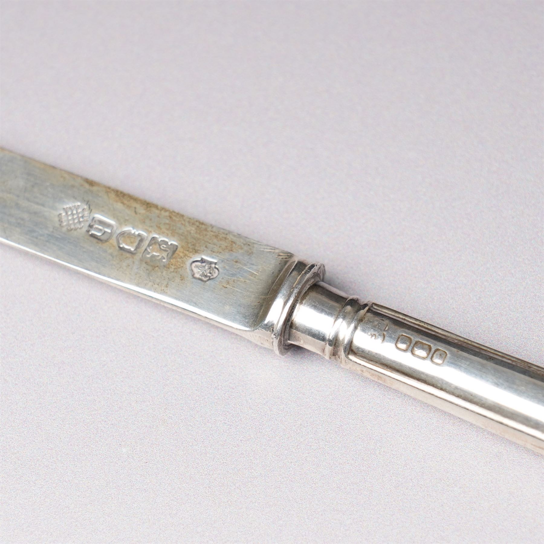 Tiffany silver teething ring marked 'Tiffany sterling 925', boxed, Junghans bedside clock in silver mounted frame, pair of silver sauce ladles and a silver knife