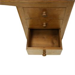 Mouseman - adzed oak kneehole dressing table or desk, the rectangular adzed top with raised back and canted corners, over an arched recessed kneehole flanked by three graduating drawers to each side with turned knob handles, raised on octagonal feet, with carved mouse signature, by the workshop of Robert Thompson of Kilburn