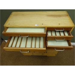  Light wood and teak dentists cabinet, thirteen graduating drawers and three cupboard doors, twin plinth base, W82cm, H11cm, D34cm  