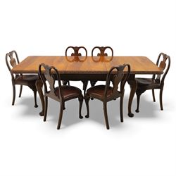 Queen Anne design walnut dining suite, comprising a rectangular dining table with carved moulded edge and rounded corners, raised on cabriole legs terminating in pad feet, together with a set of six matching dining chairs, each with shaped splat back, leather upholstered seat and cabriole supports (Extends to 230cm)