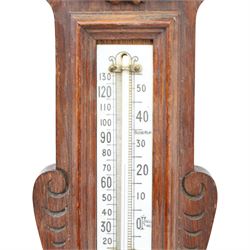 Victorian carved oak aneroid barometer, the foliate crest above a glazed thermometer, with scroll carved sides and circular dial below, H  60cm