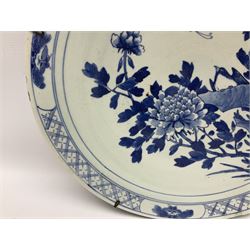 19th century Chinese blue and white charger, decorated with a bird perched upon a rock amongst blossoming peonies, and butterfly in flight, within a trellis border interspersed with butterflies in reserves, the underside rim decorated with bamboo fronds, D40cm
