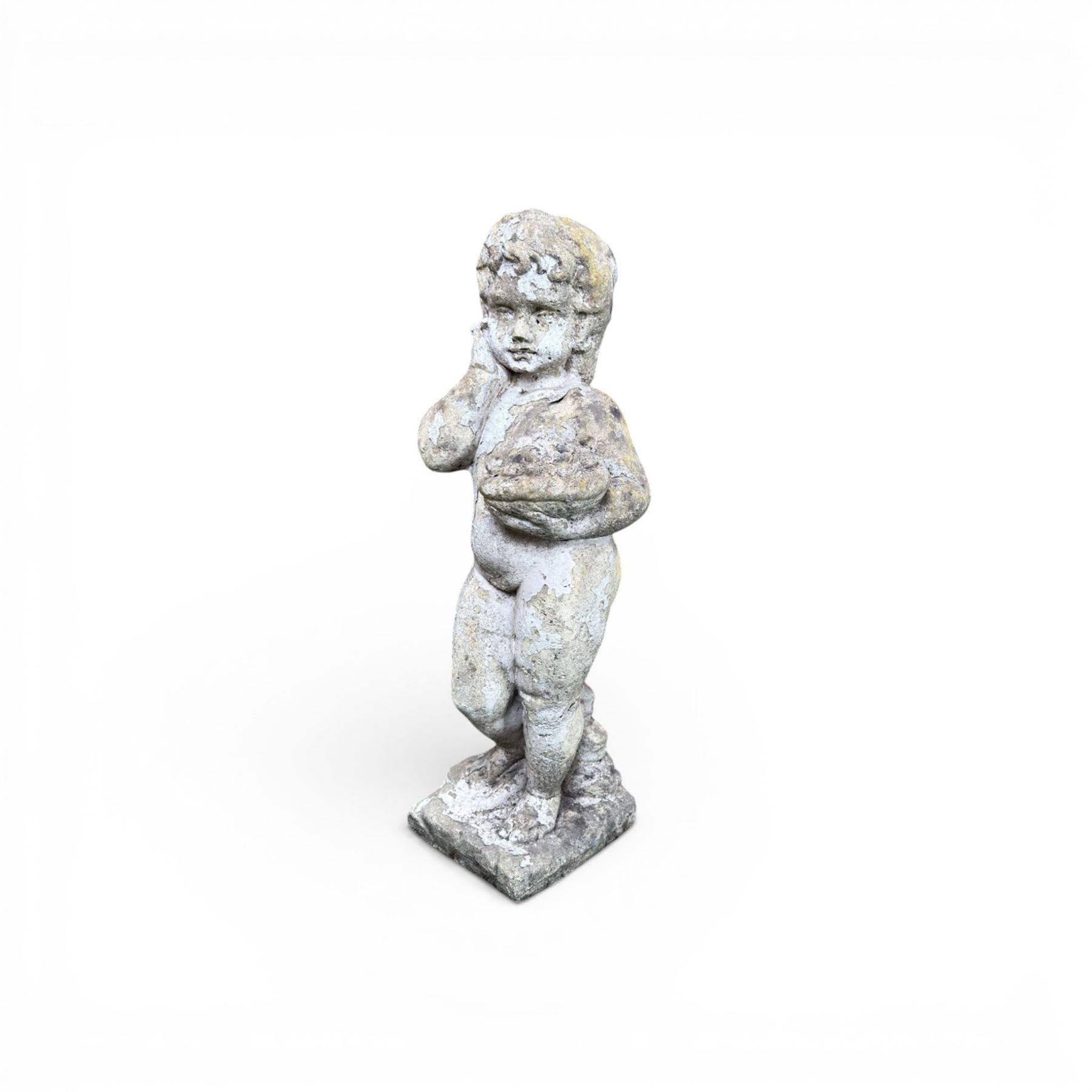 Early composition stone figure of a boy with grape basket, original flakey white paint
