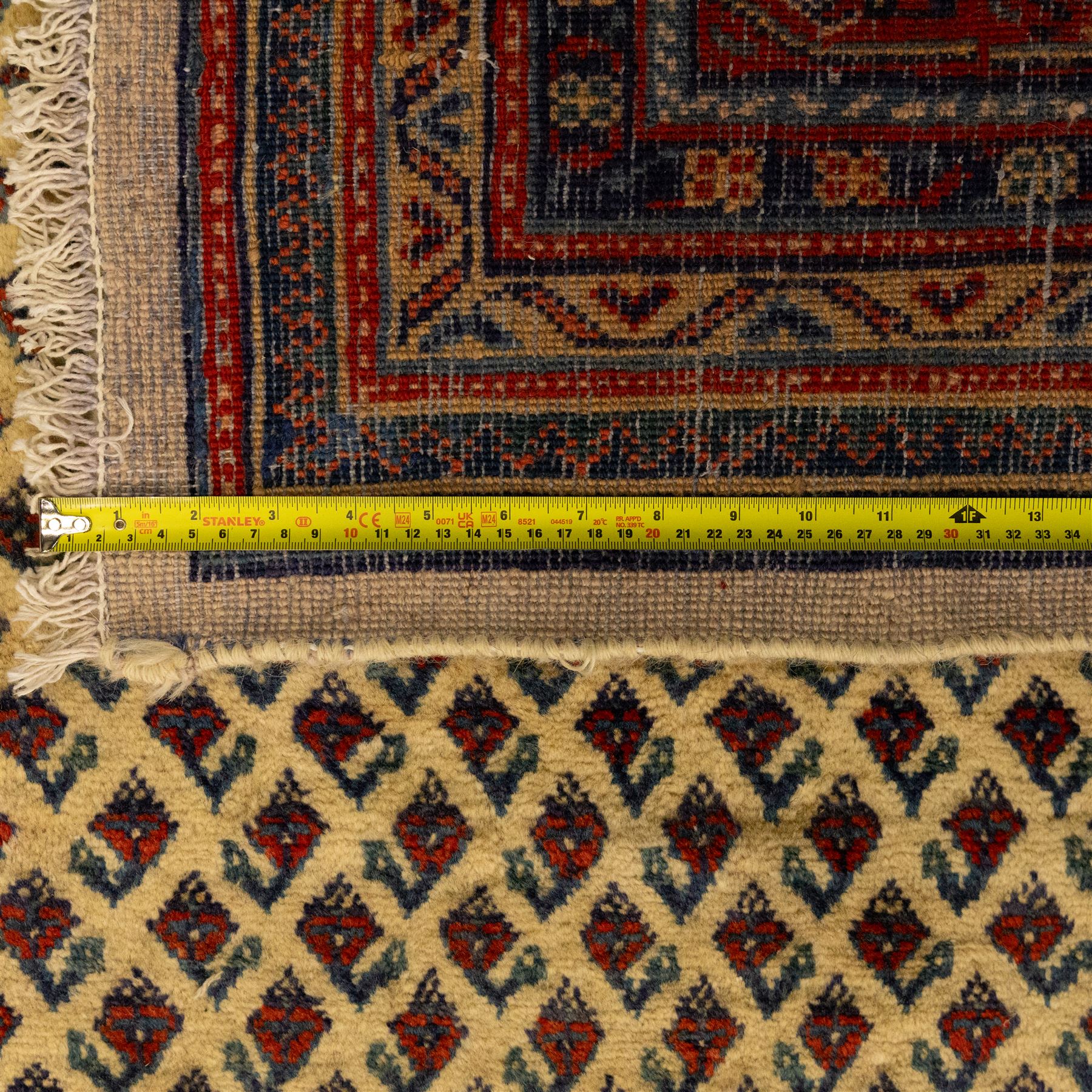North West Persian Arak hand-knotted carpet, ivory ground densely decorated with an all-over diagonal boteh lattice design within a madder red main border of stylized rosettes and botehs between multiple narrow floral guard stripes