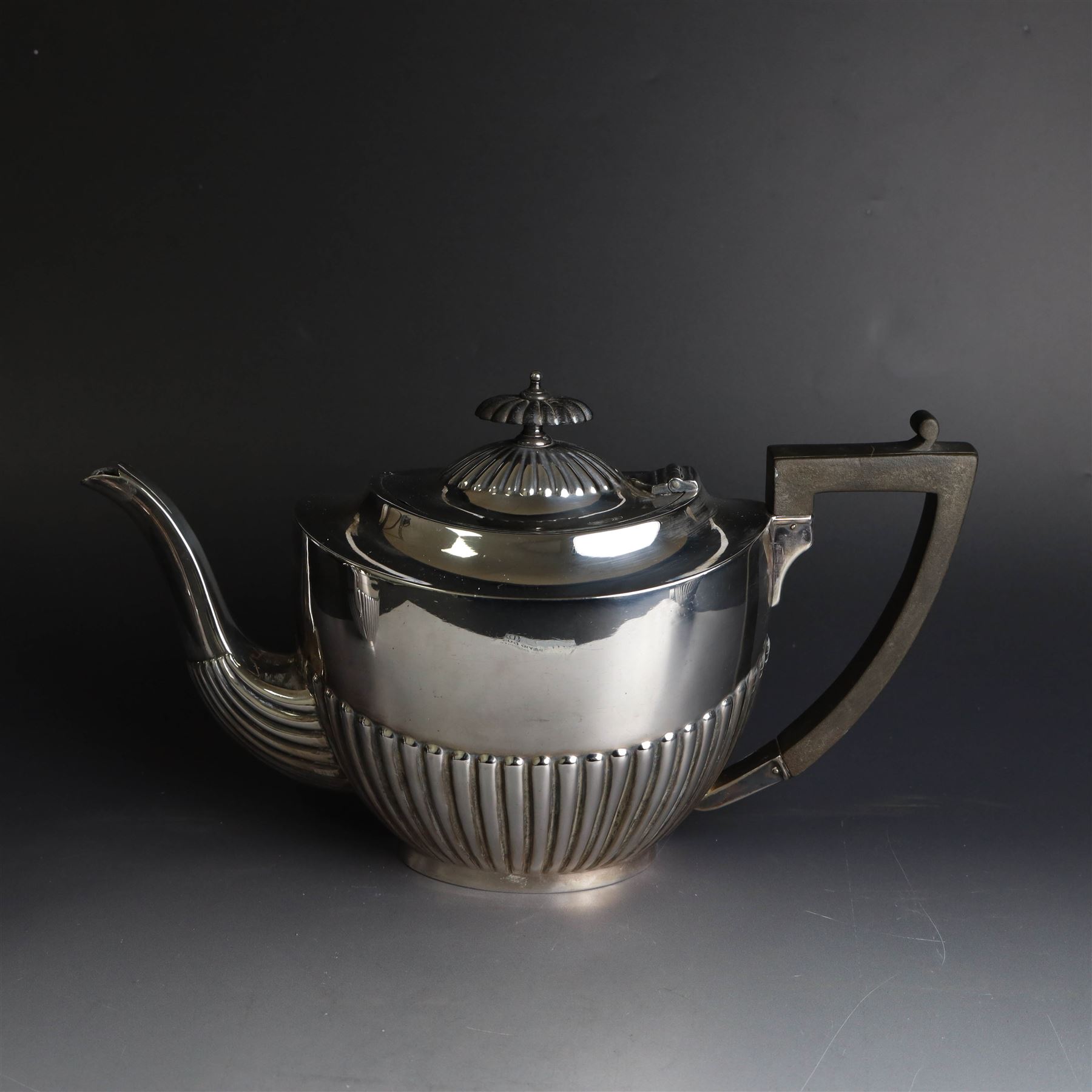 1920s silver three piece tea service, comprising teapot, twin handled open sucrier and milk jug, each of oval part fluted form, the teapot with Bakelite type handle and finial, hallmarked Cooper Brothers & Sons Ltd, Sheffield 1922