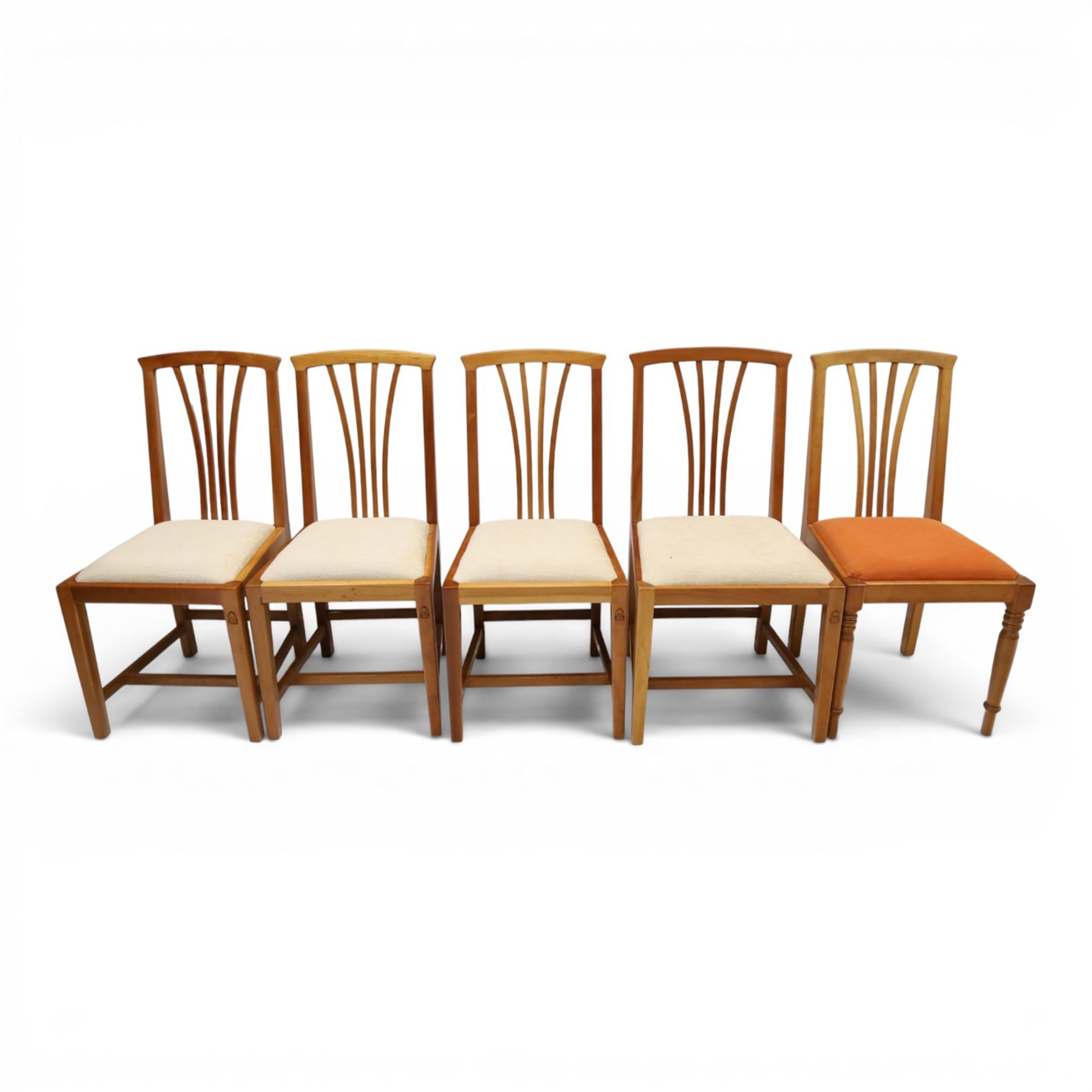 Knightman - set of nine cherrywood dining chairs, with fan splat backs and upholstered seats, raised on square legs joined by stretchers, comprising chairs of slight differing widths and one chair with turned front legs and orange upholstery and no Knight carving, the rest with recessed carved knight trademark, by Horace Knight of Old Mill Furniture, Balk near Thirsk 