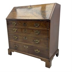 George III mahogany bureau, fall-front enclosing a fitted interior of drawers, pigeonholes and central mirrored cupboard, over four graduated cockbeaded drawers with brass batwing handles, raised on bracket feet