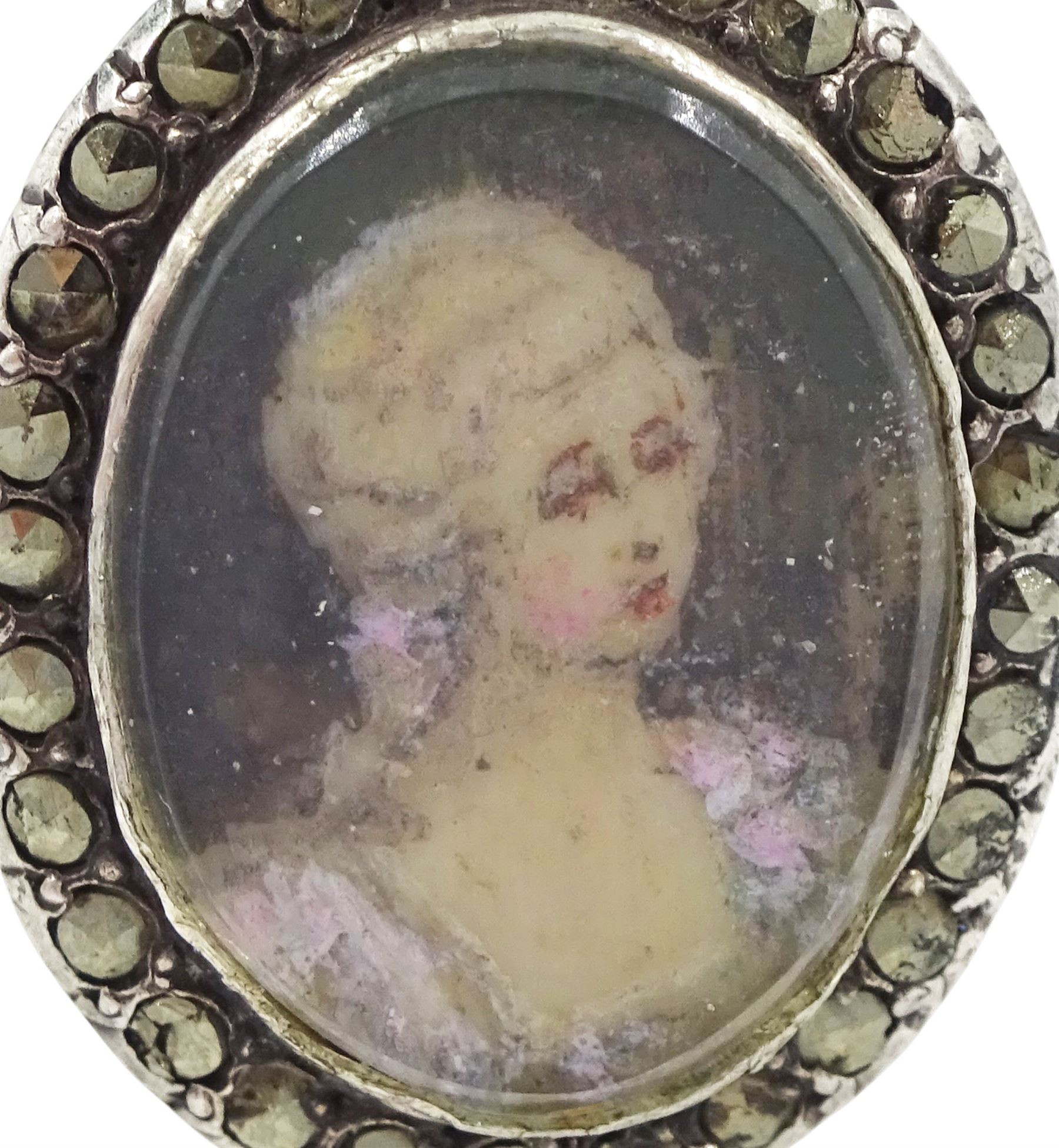 19th century French 18ct gold and silver marcasite portrait ring, set with an oval miniature of a woman on ivory, under glazed panel, with marcasite surround and trifurcated shoulders, hallmarked. This lot has been registered for sale under Section 10 of the APHA Ivory Act
