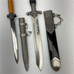 Two reproduction WW2 German daggers - 'RAD' and Red Cross officer; each with scabbard (2)