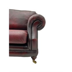 Thomas Lloyd - three seat sofa upholstered in red leather, turned front feet with brass castors