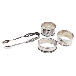 Pair of Victorian silver sugar tongs, with pierced decoration, hallmarked Hilliard & Thomason, Birmingham 1892, together with three hallmarked silver napkin rings