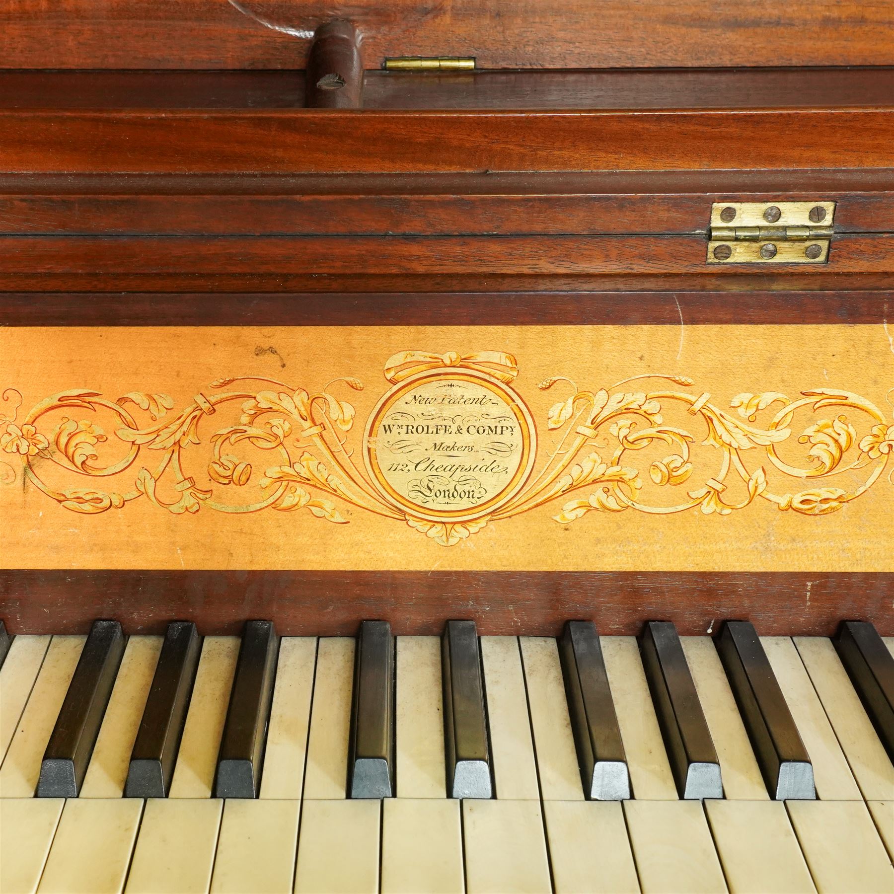 Early 19th century George IV Square Piano by William Rolfe & Co, 112 Cheapside, London, c1821. Mahogany veneered case with rosewood crossbanding and brass stringing, with sustain pedal and reeded legs on a tapered spiral with brass capitals, with three music draws beneath and a folding duet music stand, nameboard with makers name on a round gilt medallion and open silk backed fretwork to the ends, serial No 6699, double strung, English double action with 68 ivory and ebony keys, F1-C7. original strings, hammers and dampers, soundboard and bridge in good condition, with original makers written instructions on regulating the action and tuning the piano attached to the inside of the instrument. In good condition, however the action is in need of regulation and tuning.
William Rolfe is thought to have been in business between 1785 and 1828. 
Given the intricate nature of these historic instruments, specialist support will be available if required, to assist successful buyers with safe removal and onward handling. Price upon application.


This item has been registered for sale under section 10 of the APHA Ivory Act Reference PB6GL6SZ