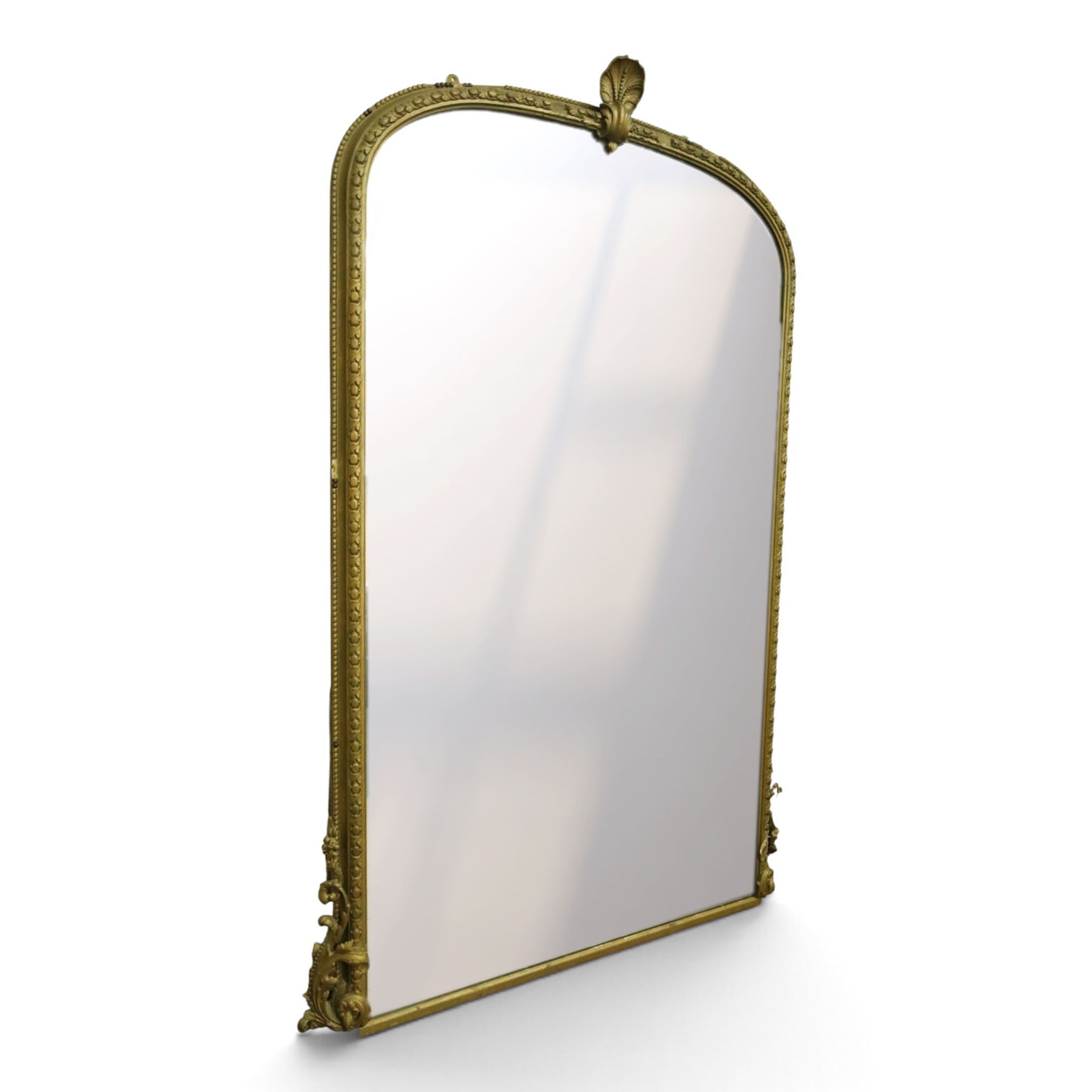 Large Country House late 19th century gilt framed overmantel mirror of arched form, the cartouche and scallop shell pediment over an egg-and-dart and beaded frame, the lower spandrels of scrolling foliate form with acanthus and flower head motifs