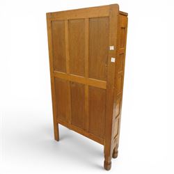 Mouseman - 1940's adzed and panelled oak corner cupboard, the raised quarter-gallery back over twin adzed panelled doors with wrought iron fittings and latch, enclosing three shaped shelves, raised on turned octagonal supports, with carved mouse signature in relief, by the workshop of Robert Thompson of Kilburn Provenance: purchased directly from the Kilburn workshop in the late 1940s