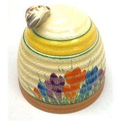 A Clarice Cliff Bizarre honey pot, of domed form with bee finial to the removable cover, decorated in the Crocus pattern, with printed mark beneath, H9cm. 
