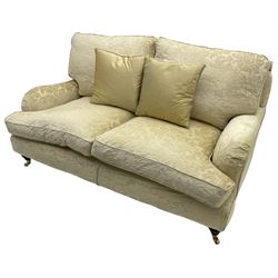 Multi-York - Howard shape two-seat sofa, upholstered in scrolling floral pattern loose covers, rolled arms, on turned front feet with brass cups and castors