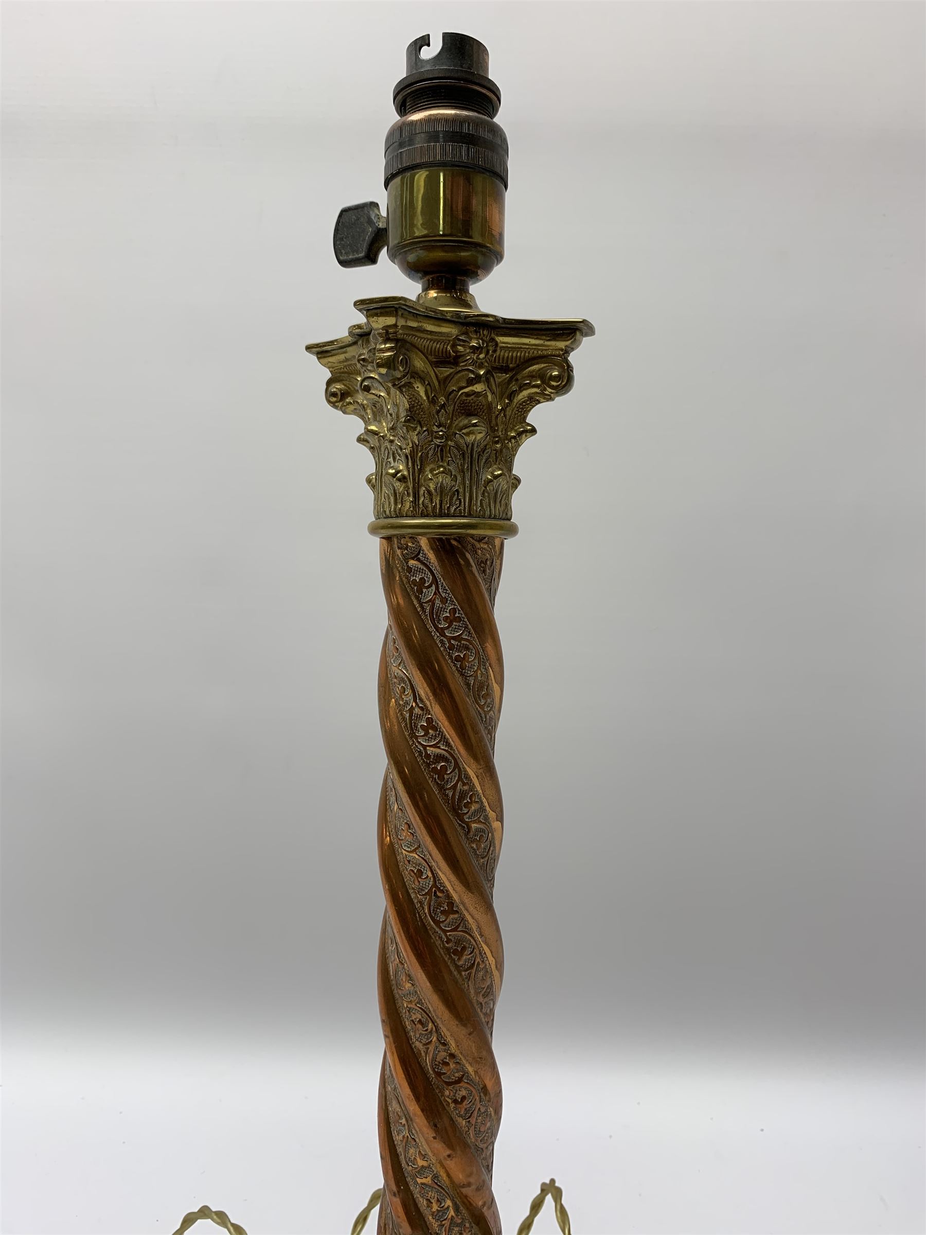 Early 20th century brass and copper Corinthian column table lamp, the square stepped brass base leading to a spiral twist copper column and brass Corinthian capital, H44.5cm 