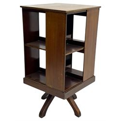 Edwardian inlaid mahogany revolving bookcase, square top, two tier open book compartments, on a cruciform base with splayed feet 