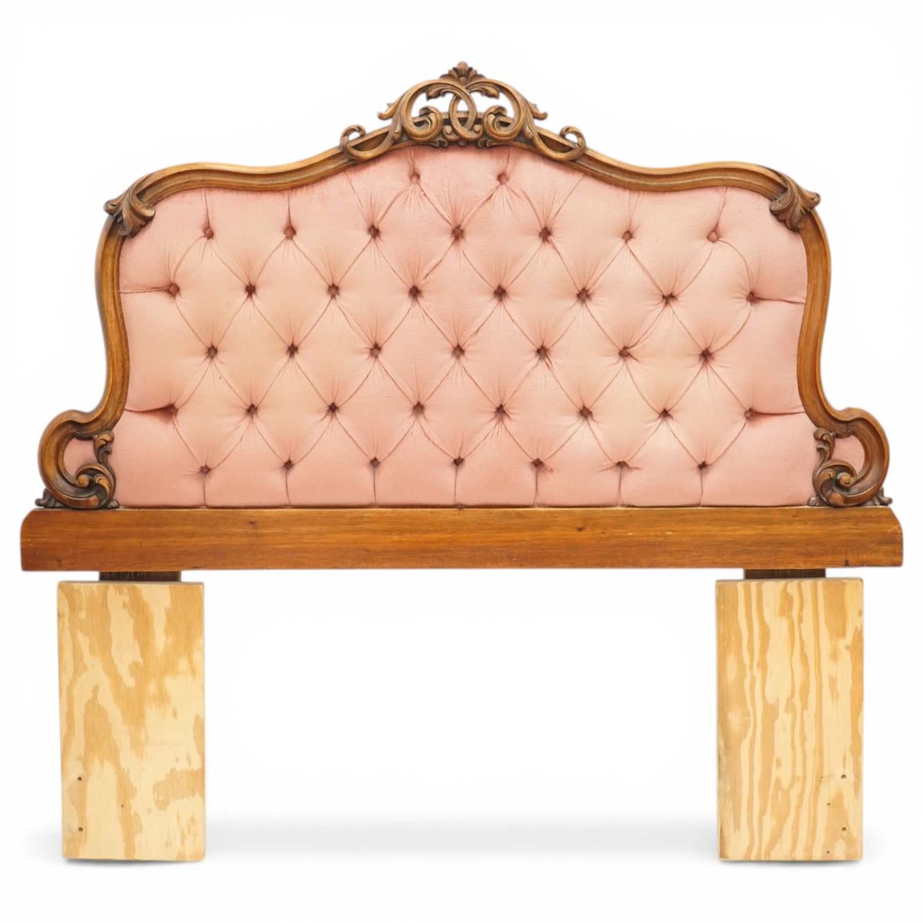 Two 20th century headboards, one with scrolled rail above a pink button backed board (H c127m, W 137cm) the second with flamed mahogany veneer (H 117cm, W 163cm)
