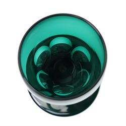 Five green wine glasses of early 19th century design with conical bowls and double knop stems on a circular foot, with pontil marks, pair of green wine glasses with chamfered stems together with an Asprey catalogue of green glass 1740-1840 and two pieces of glass fruit and leaves