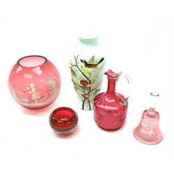  A Mary Gregory style cranberry glass vase of globular form, together with a Mary Gregory style cranberry glass bell, a Victorian cranberry glass ewer, a milk glass vase with hand painted decoration, and a small bowl with captive air bubble decoration.   