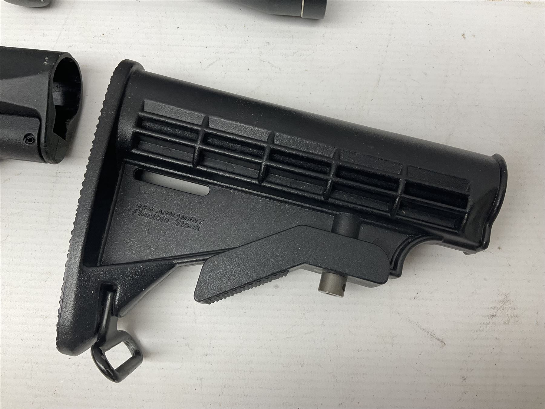 Assorted shooting accessories including two telescopic sights, red dot sight,  two bi-pods, spirit level mount, two gun butts and two forward handles