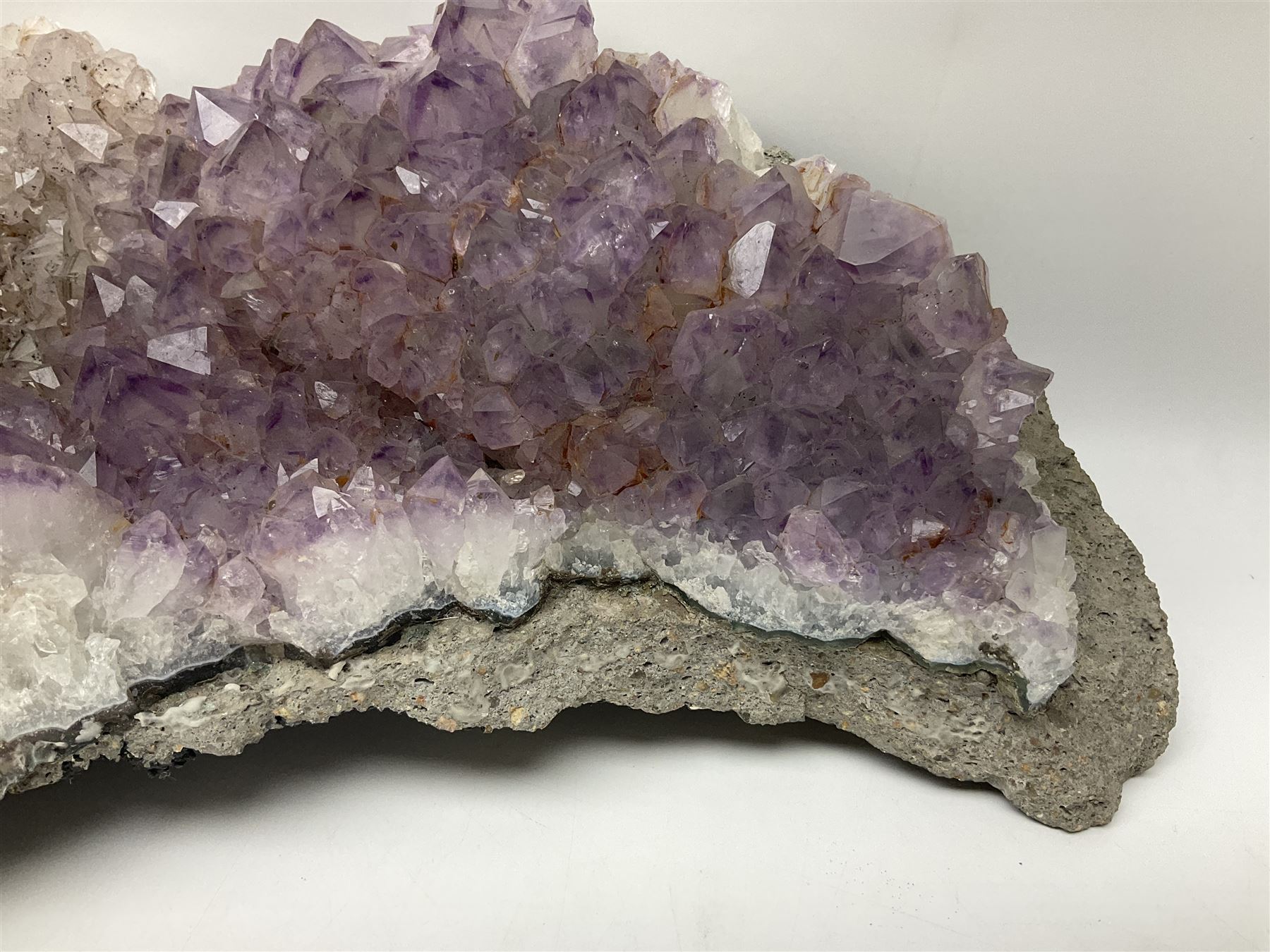Amethyst crystal geode cluster, with well-defined crystals of various sizes, H13cm, L46cm