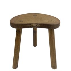 'Mouseman' oak three-legged stool, kidney shaped dished seat carved with mouse signature to edge, by Robert Thomas of Kilburn