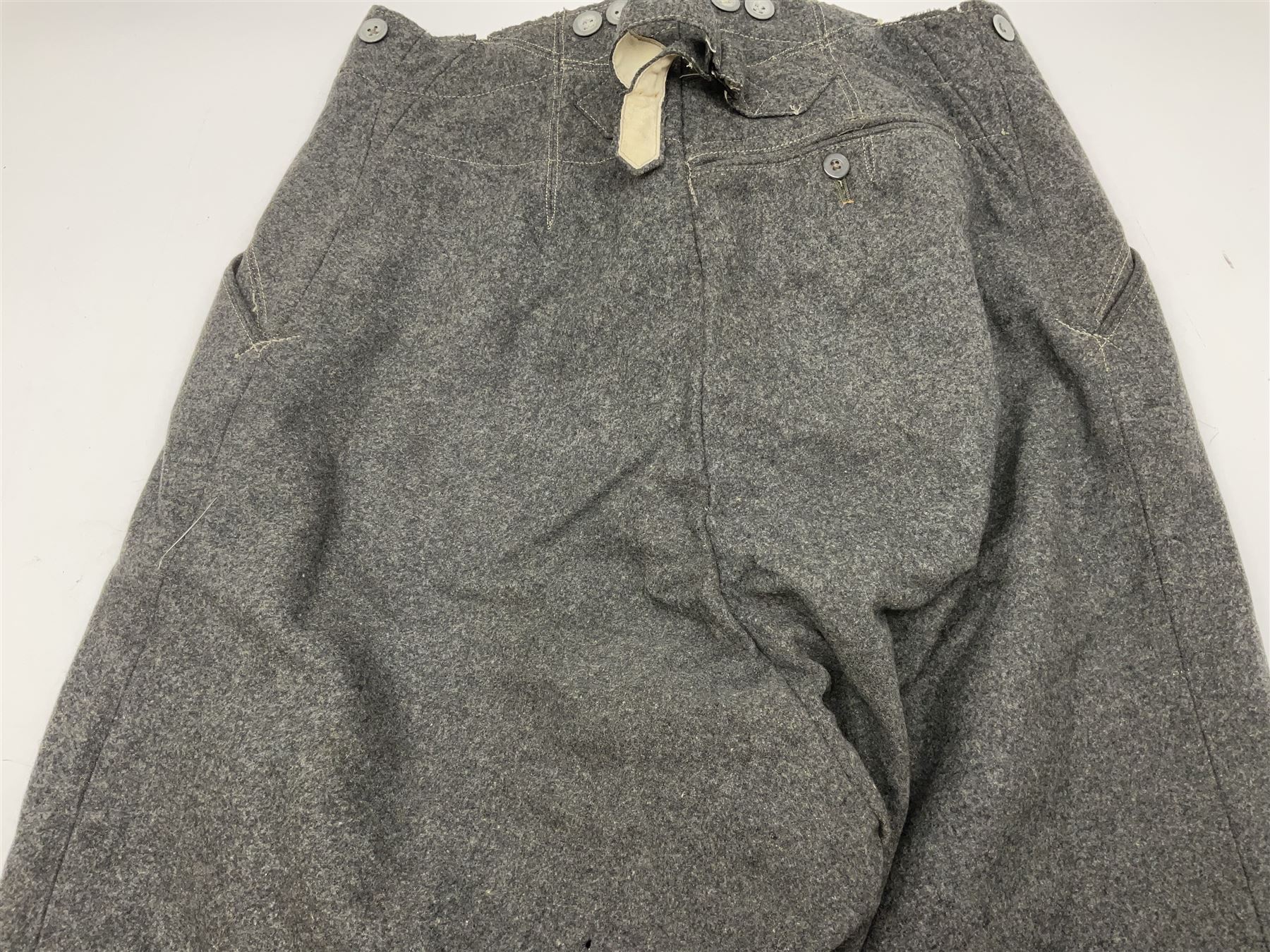 Pair of WW2 German Other Ranks trousers c1940-42, stamped C.& A. Brenninkmeyer Workstatten; WW2 German Army webbing belt with steel 'Gott Mit Uns' buckle; and WW2 German leather belt with 'Stahlhelm' (Steel Helmet League) members buckle (3)