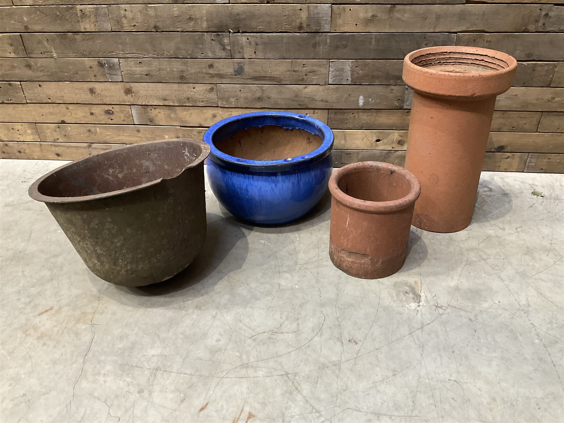 Cast iron cauldron set pot with 2 terracotta chimney pots and 2 terracotta planters,