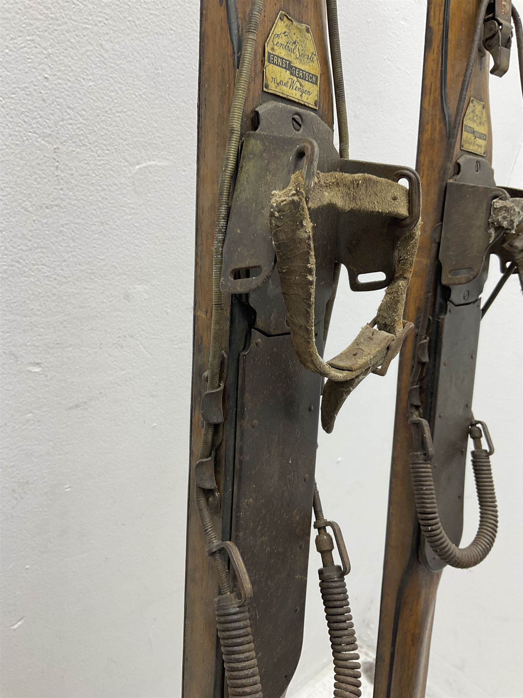 Pair of 1930s wooden skis, with painted metal runners beneath stamped Attenhofer, with retailers label for Ernst Gertsch Central Sports, L206cm