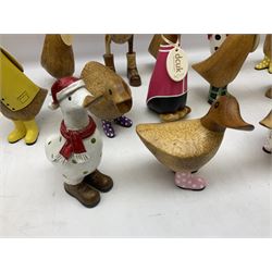 Quantity of the Duck Company UK DCUK carved bamboo root ducks, modelled wearing rain hats and rain boots etc, together with other similar carved wood ducks, tallest H26cm