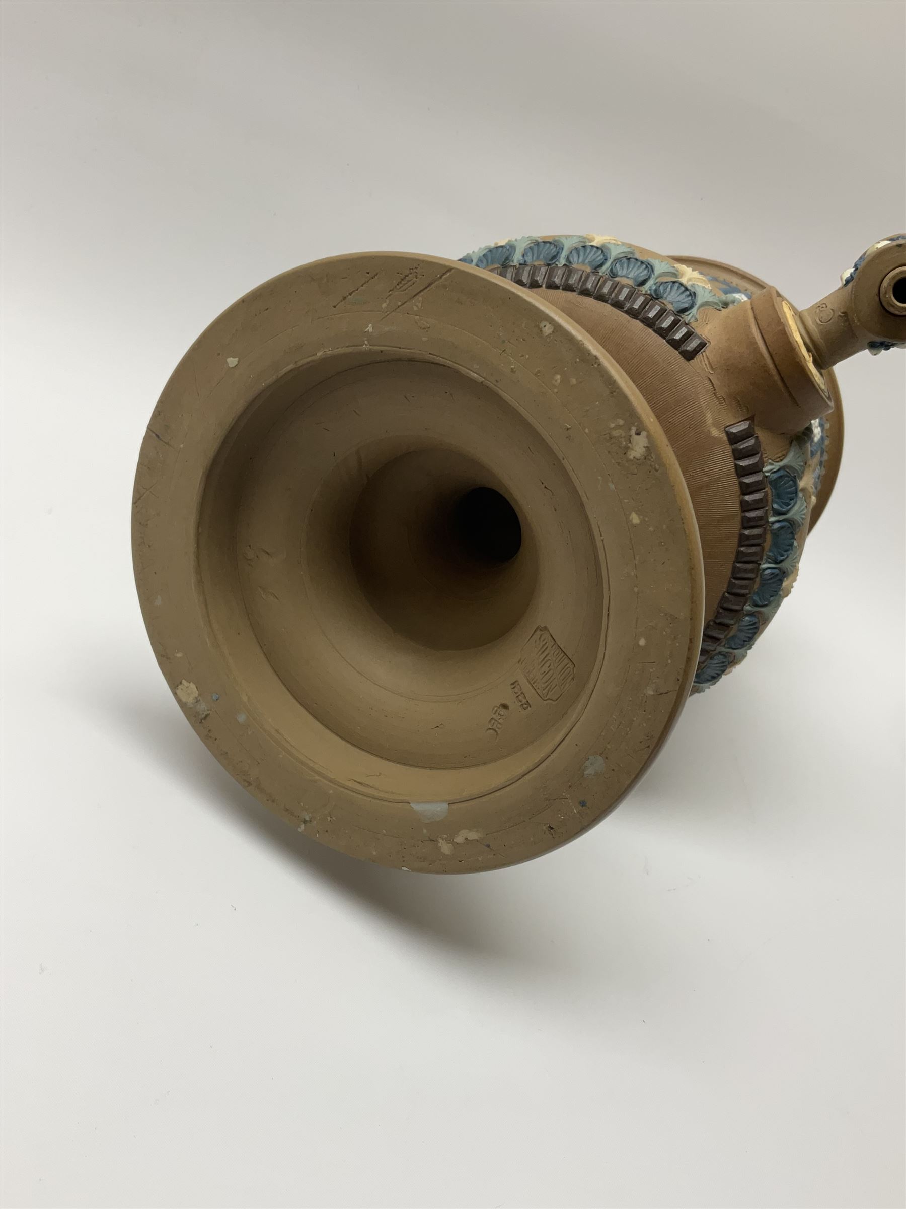 A late 19th century Doulton Lambeth stoneware water filter with original spigot, decorated with relief moulded foliate bands, with impressed marks and monogrammed for Laura Gooderham beneath, H34cm. 