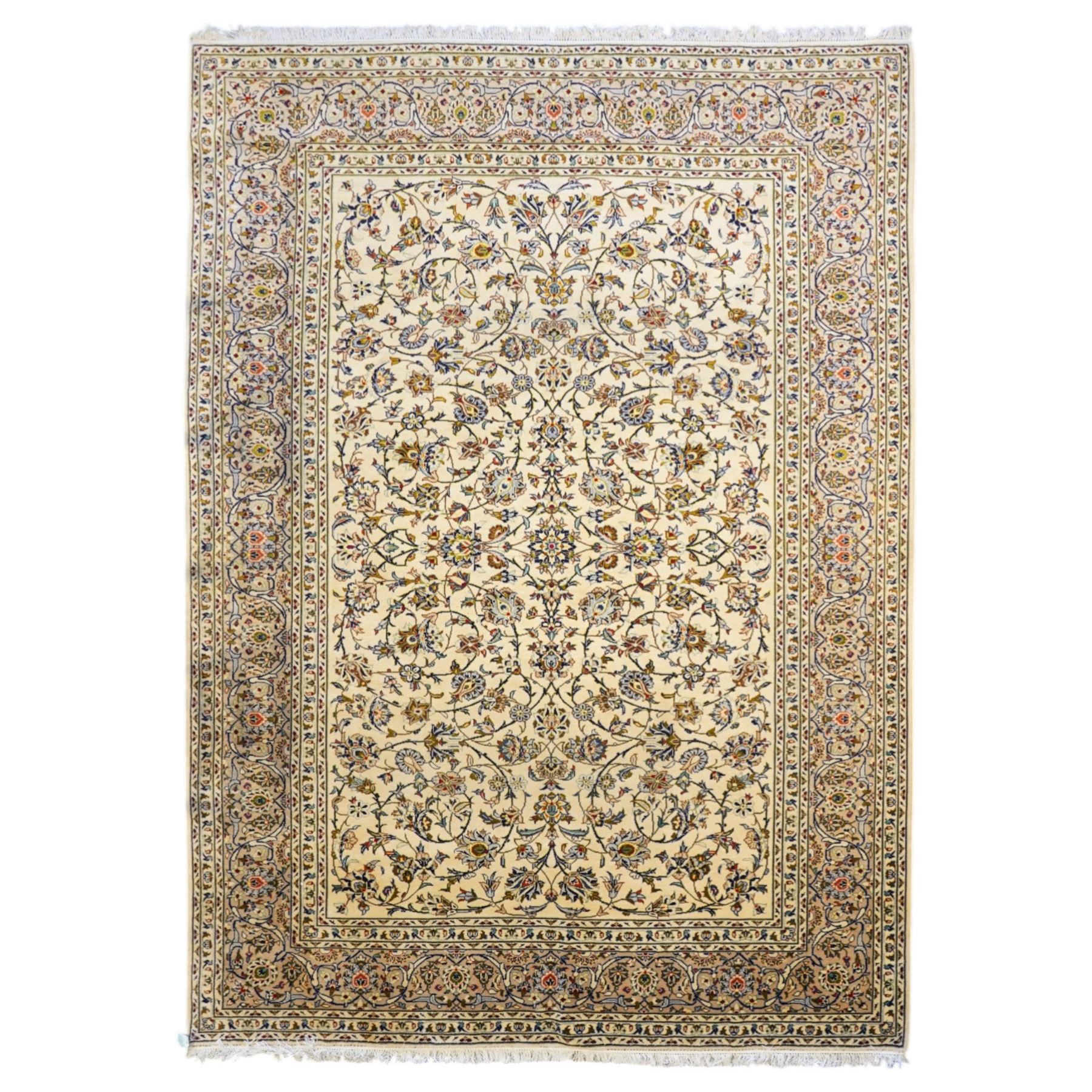 Central Persian Kashan hand-knotted carpet, ivory field decorated with an all-over scrolling floral vine design incorporating stylized palmettes, rosettes, and foliate sprays in the Shah-Abassi style enclosed by a series of floral vine borders and multiple narrow guard stripes, cotton fringe ends 