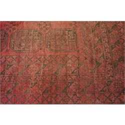 Afghan crimson ground Bokhara rug, the field with three rows of repeating Gul motifs, within six concentric guard bands decorated with repeating geometric patterns