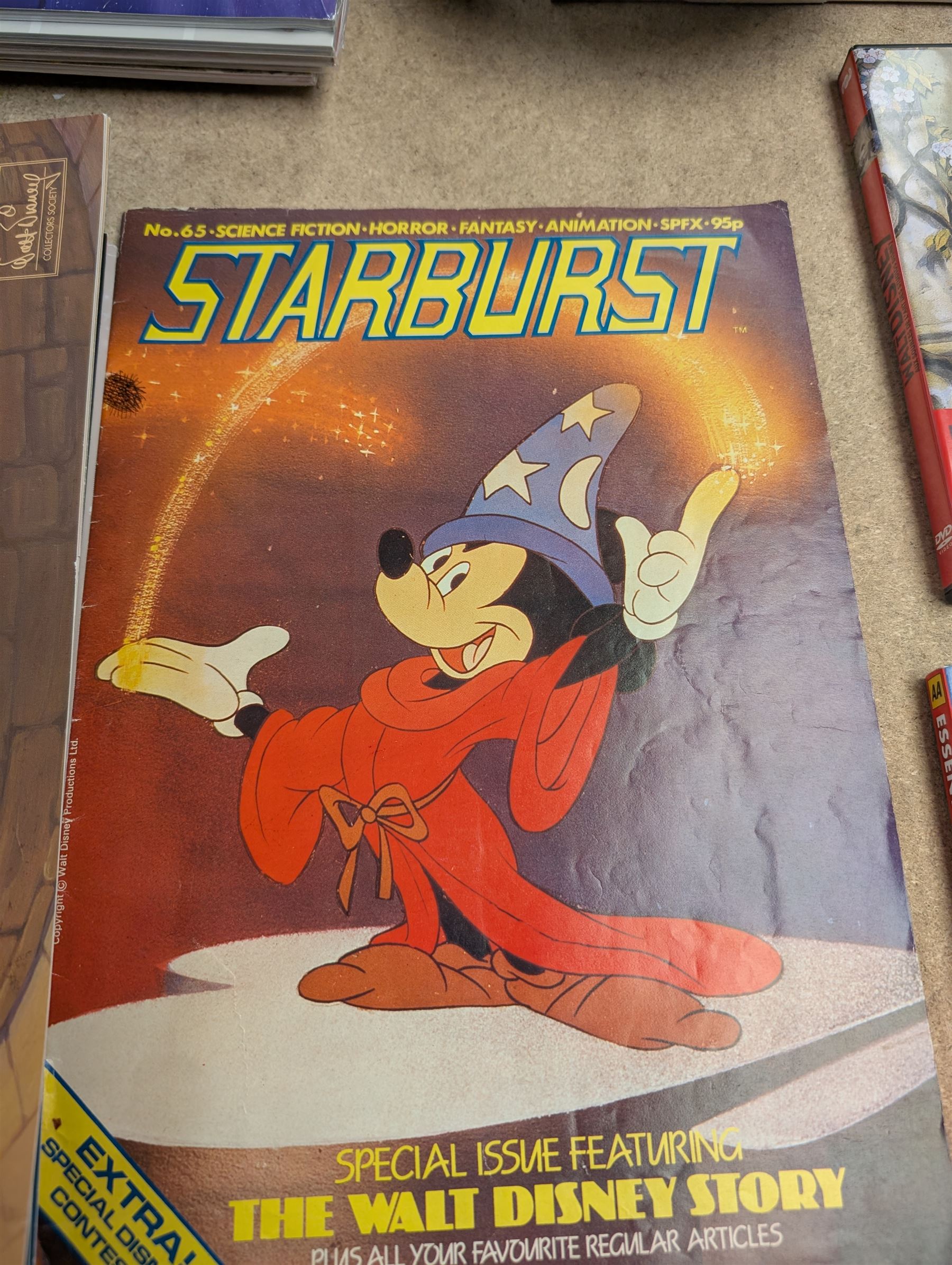 Collection of Disney memorabilia and ephemera, including Walt Disney Treasures DVD, two Disney Villains mugs, enamel pins, Mickey Mouse D23 fan club pack, Disney Twenty-Three magazines, Sketches magazines, etc