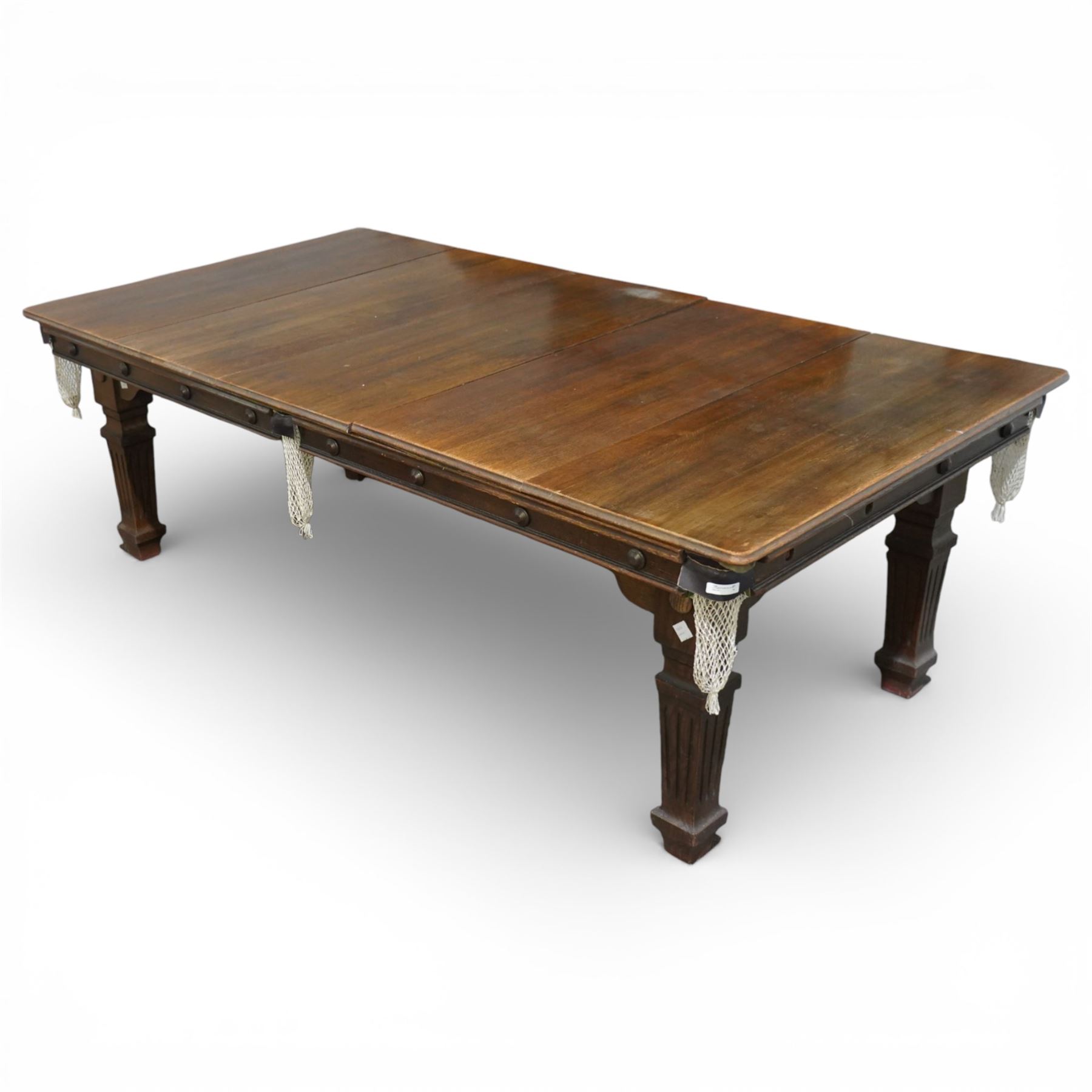 Riley - late 20th century Riley slate bed snooker table with dining table leaves, rectangular baize playing surface within a moulded hardwood frame with studded frieze rails and leather pocket mounts with net bags, raised on four square tapering fluted supports with block feet, with associated dining table leaves, with various cues, chalks, snooker and eight ball pools
