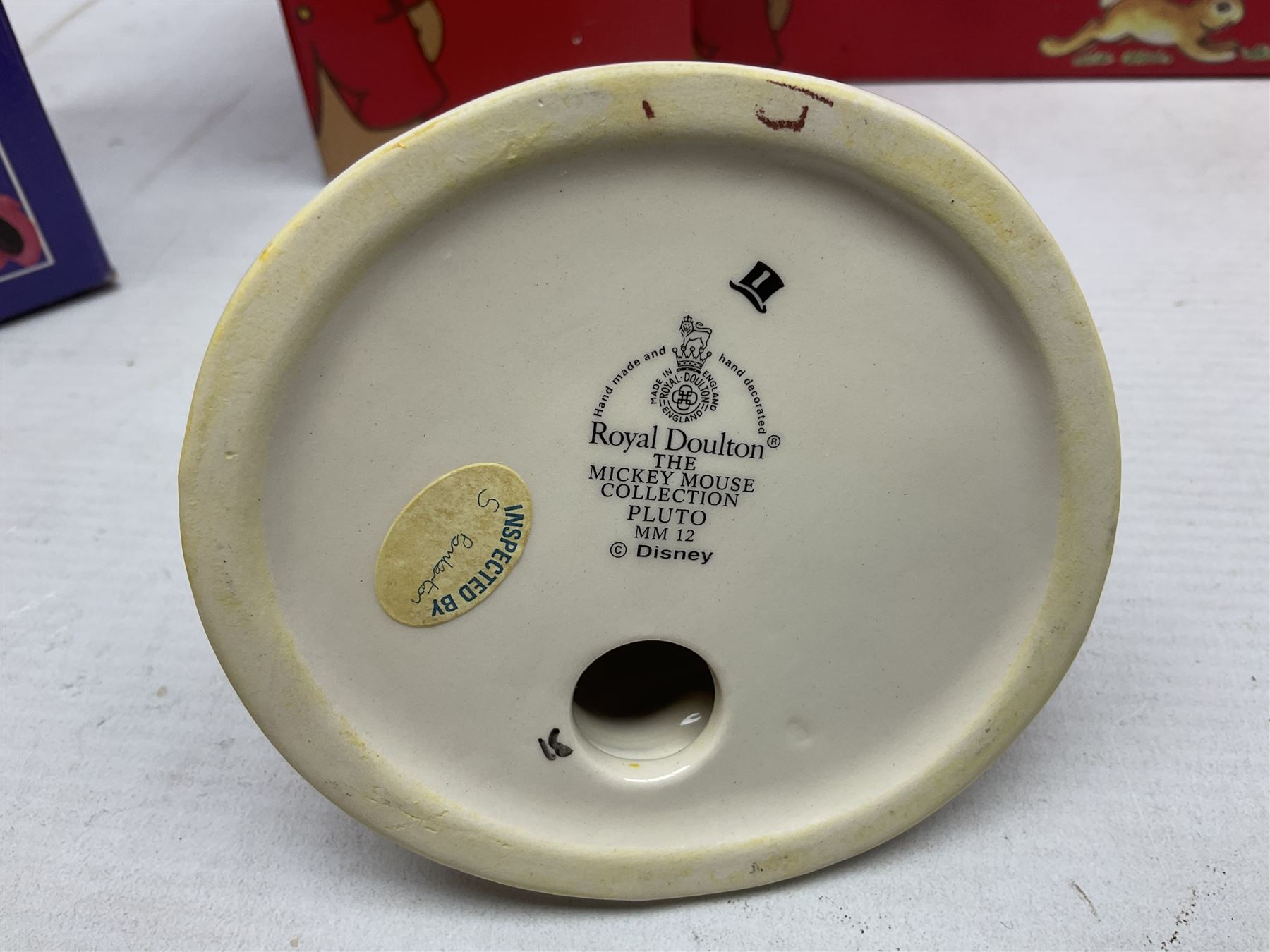 Royal Doulton The Mickey Mouse Collection Pluto figure, Coalport Characters The Snowman Dressing Up figure, three Royal Doulton Bunnykins figures comprising Policeman, Morris Danger and Eskimo, and display stand, Royal Doulton John Beswick Tiggy Winkle, Royal Albert Beatrix Potter Peter Postbag and three Goebel Hummel figures, all boxed