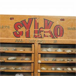 Sylko display cabinet, with fifty drawers with glass fronts, each drawer divided into eight sections displaying shells, with two door cupboard beneath