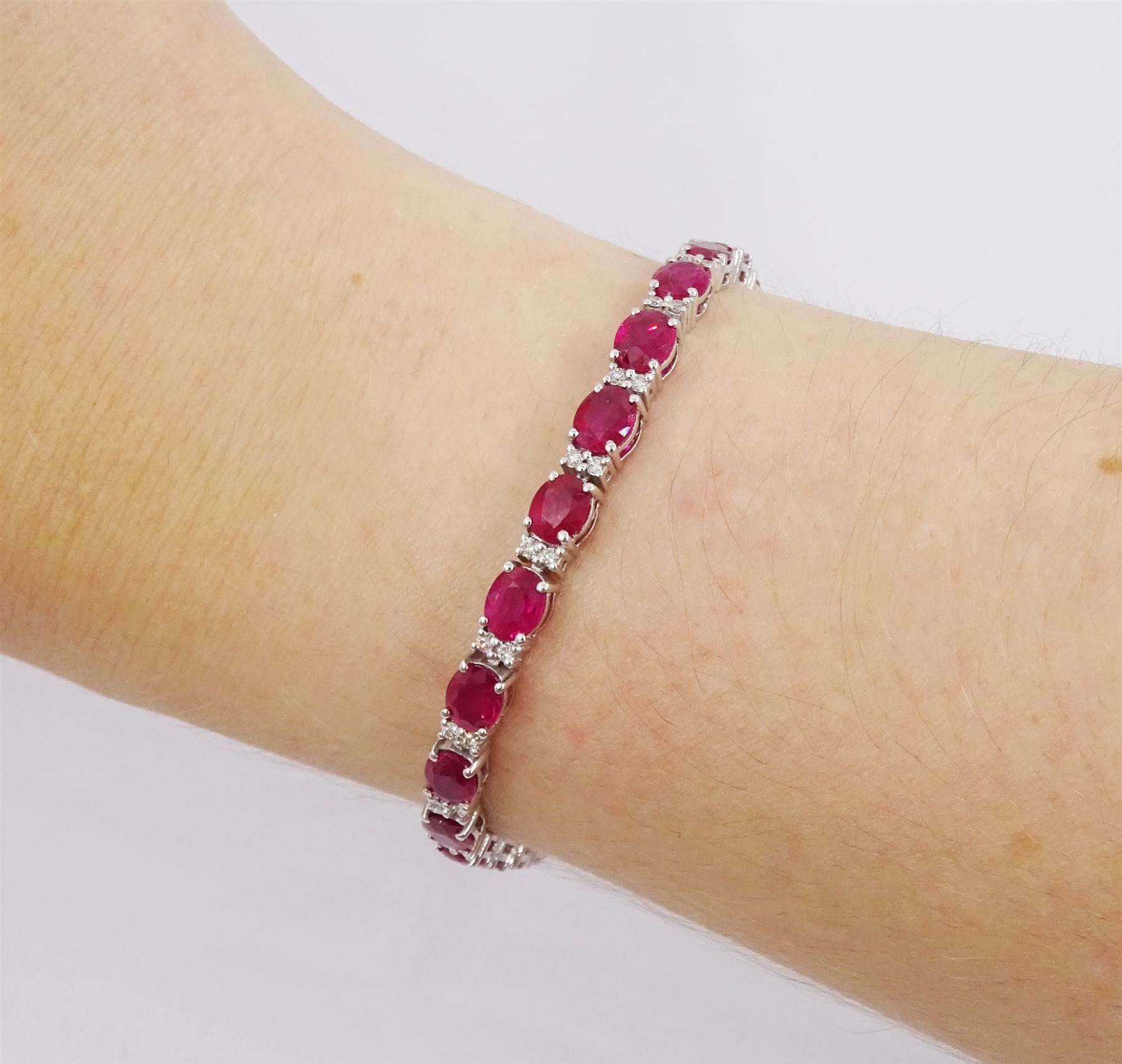18ct white gold oval cut ruby and round brilliant cut diamond bracelet, total ruby weight approx 9.80 carat, total diamond weight approx 0.50 carat