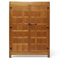 Mouseman - early-to-mid-20th century panelled and adzed double wardrobe, the arcade carved cresting rail over two panelled doors, with wrought metal hinges and latch, deep relief carved mouse signature, the interior fitted with hanging rail, by the workshop of Robert Thompson of Kilburn