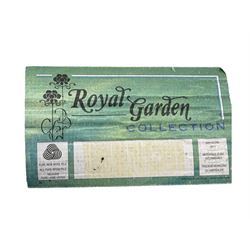 Contemporary 'Royal Garden' wool pile rug, central cream field with a smaller red rectangular panel containing scattered animal and geometric motifs, bordered by a wide indigo band decorated with stylised figures, animals, and tree motifs