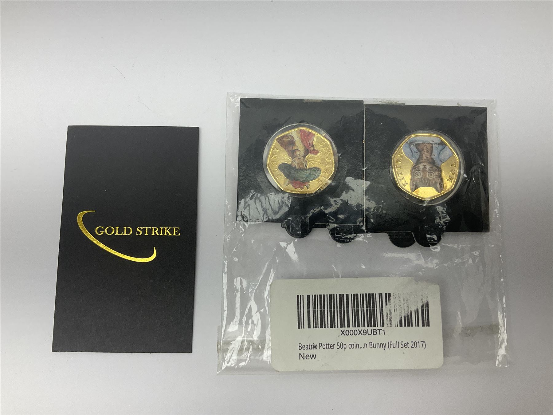 Four gold plated and coloured commemorative fifty pence coins, comprising 2017 Benjamin Bunny, Mr Jeremy Fisher, Tom Kitten and The Tale of Peter Rabbit, with Gold Strike certificate of authenticity