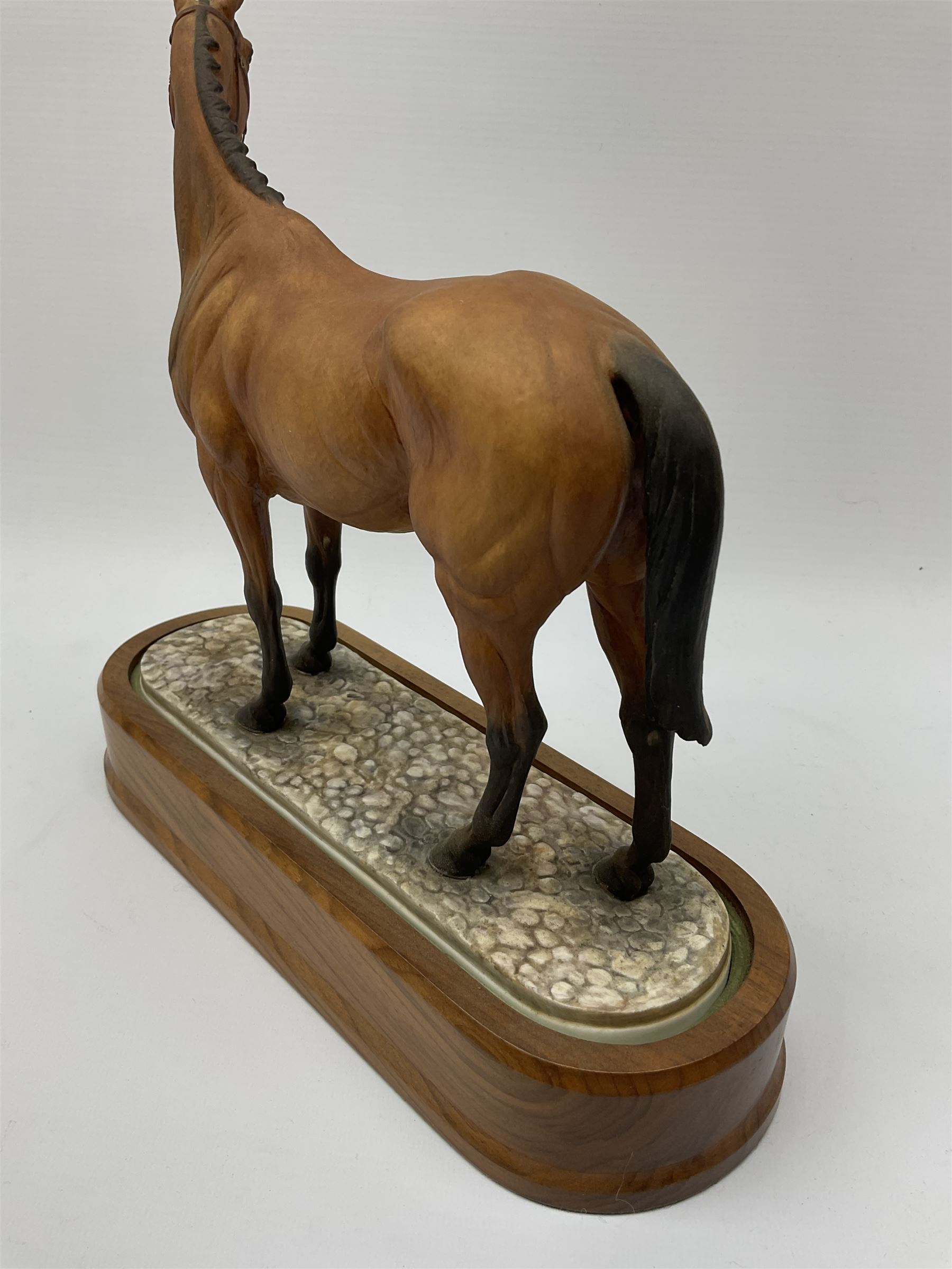 A Royal Worcester limited edition figure, Arkle, owned by the Duchess of Westminster, modelled by Doris Lindner, on wooden base, H27cm. 